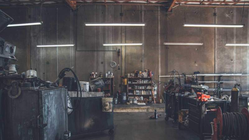 mechanic working on a car engine in workshop